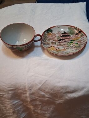 Antique cup and saucer set in white, red, green, gold